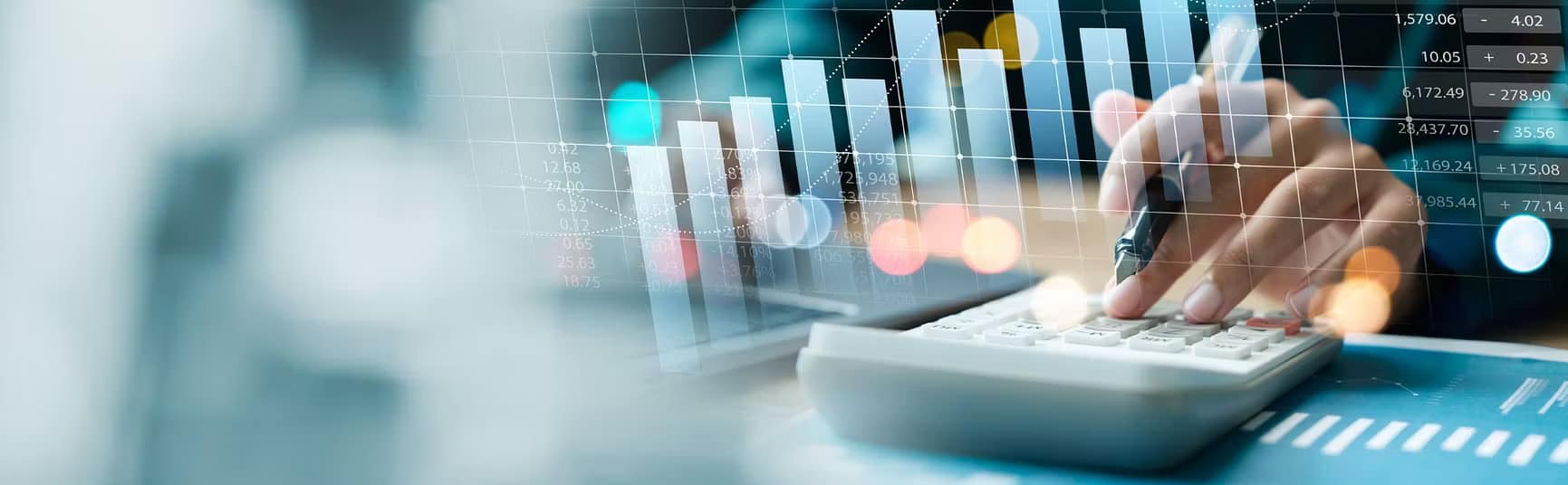 Person using laptop with financial charts representing social housing property investment calculator for estimating returns